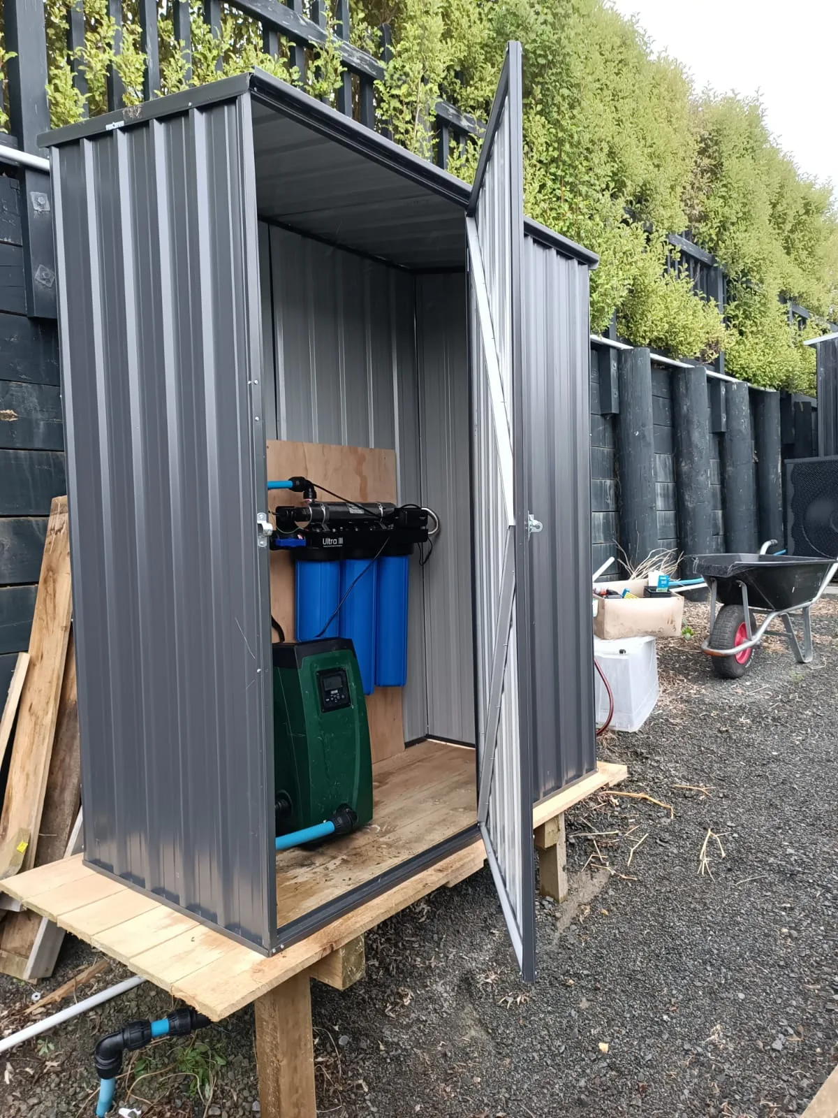 Whole house water filtration cabinet installed by Filtration Station, UV unit and filter housings